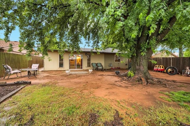 12414 SW 15th Ter, Yukon, OK 73099 - rear view of house with a fenced backyard and a patio