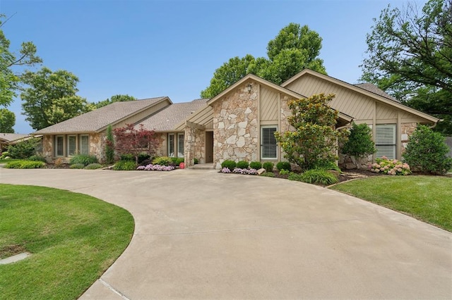 11209 Thorn Ridge Rd, Oklahoma City, OK 73120 - view of front of property with stone siding, a front lawn, and curved driveway