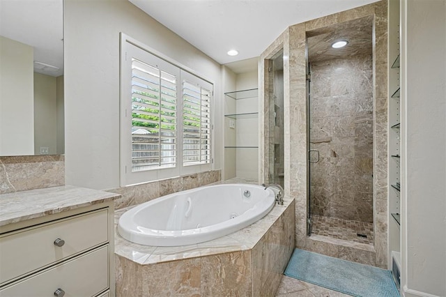 11209 Thorn Ridge Rd, Oklahoma City, OK 73120 - bathroom with vanity, a jetted tub, a stall shower, and tile patterned floors
