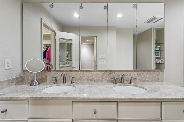 11209 Thorn Ridge Rd, Oklahoma City, OK 73120 - bathroom featuring double vanity and a walk in closet