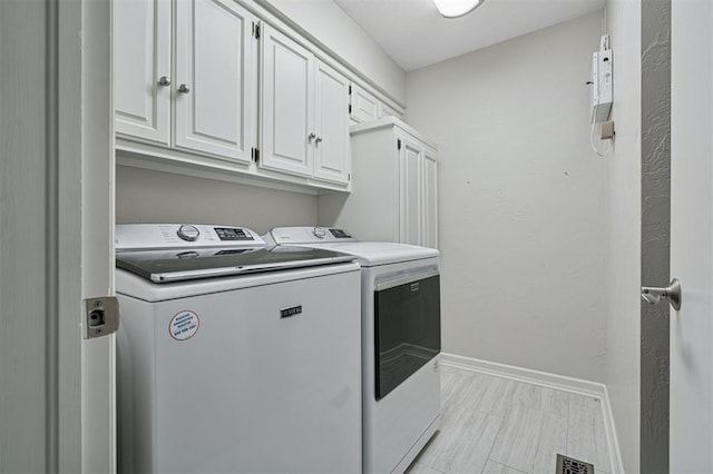 11209 Thorn Ridge Rd, Oklahoma City, OK 73120 - laundry area with washing machine and clothes dryer and cabinet space