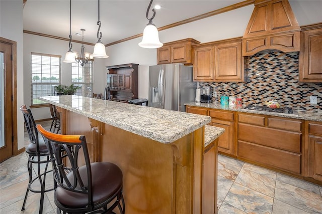 6813 Chelsey Ln, Oklahoma City, OK 73132 - kitchen featuring appliances with stainless steel finishes, backsplash, a kitchen breakfast bar, a kitchen island, and brown cabinetry