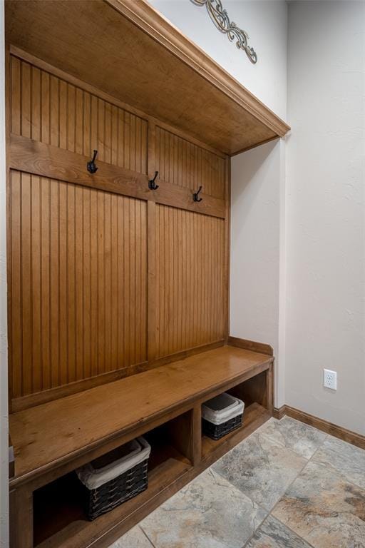 6813 Chelsey Ln, Oklahoma City, OK 73132 - mudroom featuring baseboards and stone finish floors