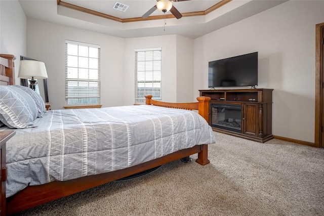 6813 Chelsey Ln, Oklahoma City, OK 73132 - bedroom featuring crown molding, a tray ceiling, carpet floors, and ceiling fan