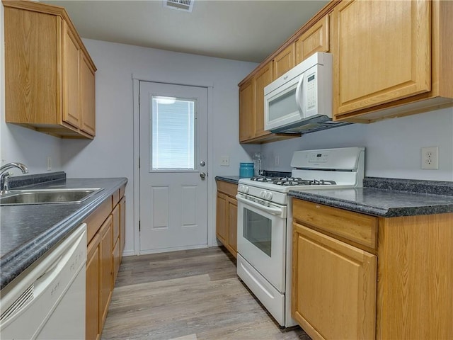 524 E Grant Ave, Guthrie, OK 73044 - kitchen with white appliances, dark countertops, and light wood-type flooring