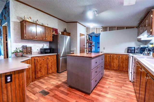 910903 S 3444th Rd, Chandler, OK 74834 - kitchen featuring freestanding refrigerator, light wood finished floors, black microwave, wooden counters, and ornamental molding