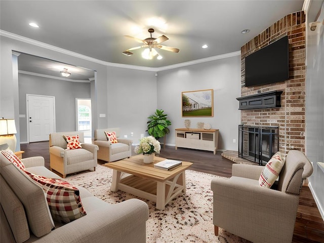 3922 Deer Xing, Edmond, OK 73025 - living room featuring a brick fireplace, ceiling fan, wood finished floors, ornamental molding, and recessed lighting