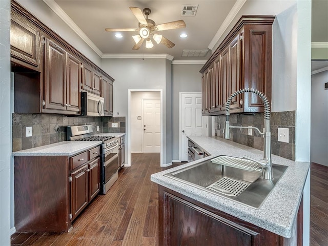 3922 Deer Xing, Edmond, OK 73025 - kitchen featuring appliances with stainless steel finishes, a ceiling fan, crown molding, light countertops, and recessed lighting