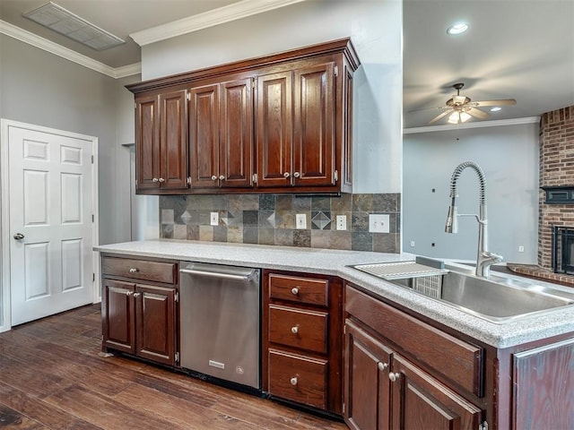 3922 Deer Xing, Edmond, OK 73025 - kitchen featuring stainless steel dishwasher, a ceiling fan, crown molding, dark wood-style flooring, and decorative backsplash