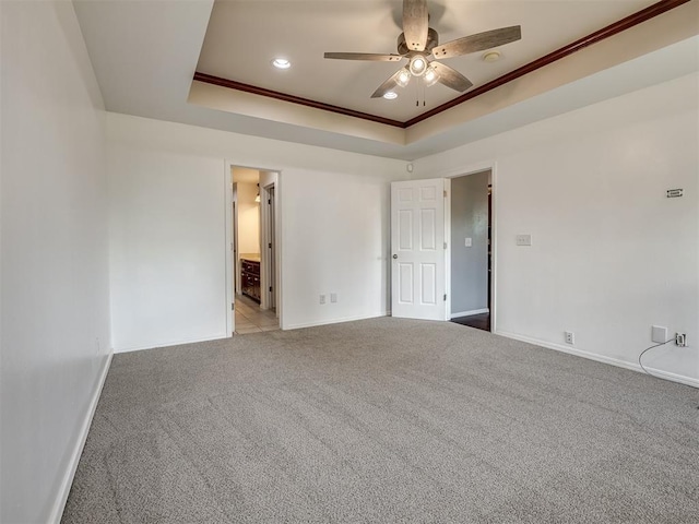 3922 Deer Xing, Edmond, OK 73025 - unfurnished room featuring a ceiling fan, light colored carpet, a tray ceiling, and ornamental molding