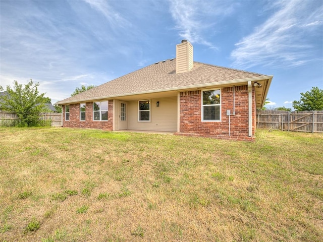 3922 Deer Xing, Edmond, OK 73025 - back of property featuring a chimney, brick siding, and roof with shingles