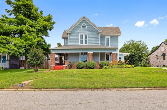 811 S Barker Ave, El Reno, OK 73036 - view of front of property featuring covered porch, a front lawn, and brick siding