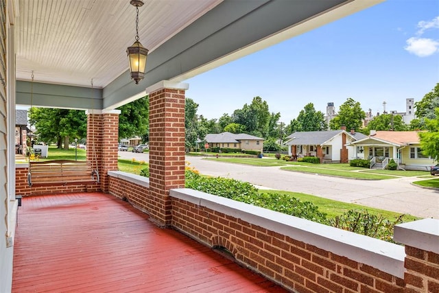 811 S Barker Ave, El Reno, OK 73036 - wooden porch featuring a residential view