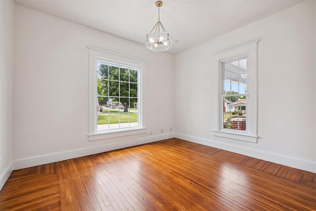 811 S Barker Ave, El Reno, OK 73036 - empty room with a chandelier and hardwood / wood-style floors