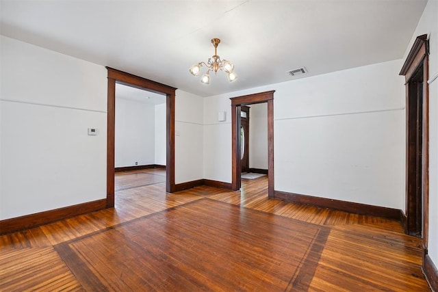 811 S Barker Ave, El Reno, OK 73036 - spare room featuring a chandelier and wood-type flooring