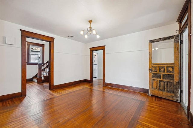 811 S Barker Ave, El Reno, OK 73036 - unfurnished room featuring a chandelier, hardwood / wood-style floors, and stairs