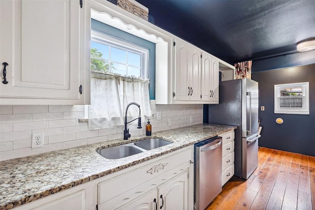 811 S Barker Ave, El Reno, OK 73036 - kitchen with appliances with stainless steel finishes, white cabinetry, decorative backsplash, and light stone counters