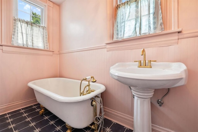 811 S Barker Ave, El Reno, OK 73036 - full bathroom featuring a freestanding bath and a wainscoted wall