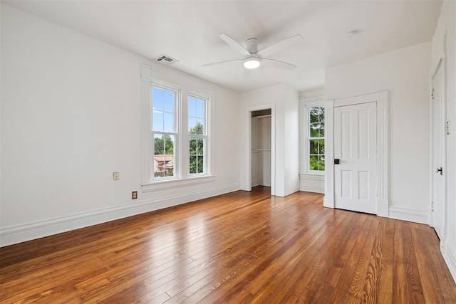811 S Barker Ave, El Reno, OK 73036 - unfurnished bedroom with wood-type flooring and ceiling fan