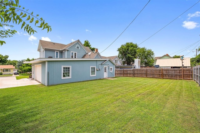 811 S Barker Ave, El Reno, OK 73036 - rear view of house featuring concrete driveway and a garage