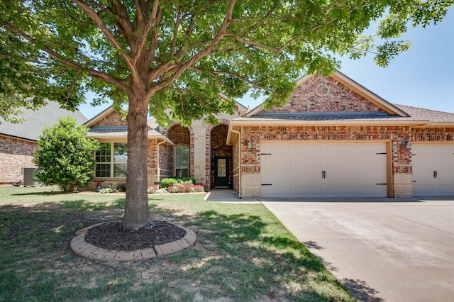 637 Branch Line Rd, Yukon, OK 73099 - view of front of house with brick siding, an attached garage, driveway, and a front yard