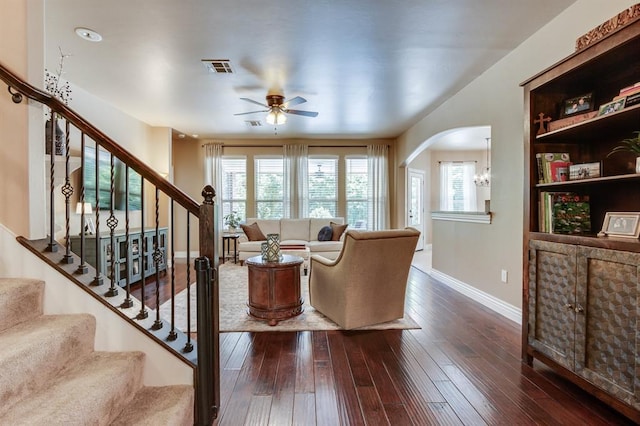 637 Branch Line Rd, Yukon, OK 73099 - living room featuring a ceiling fan, dark wood-type flooring, arched walkways, and stairway