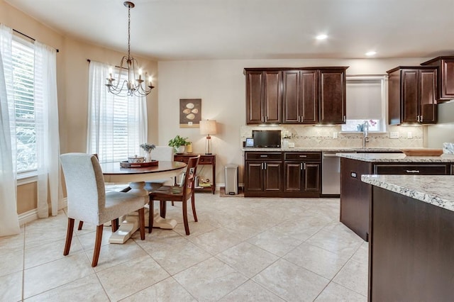 637 Branch Line Rd, Yukon, OK 73099 - kitchen with dishwasher, a chandelier, dark brown cabinets, tasteful backsplash, and light stone counters