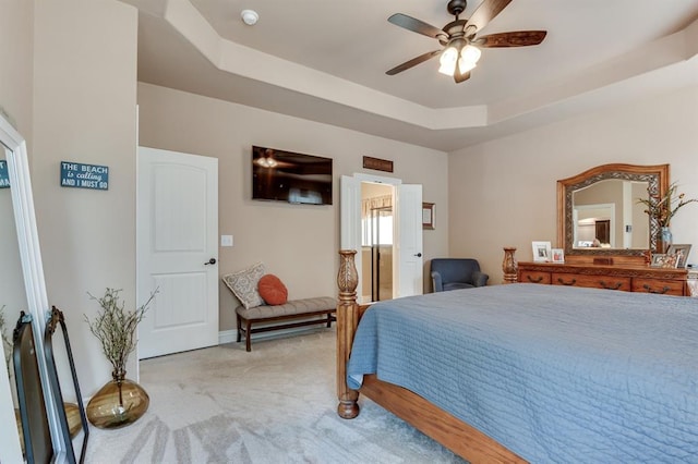 637 Branch Line Rd, Yukon, OK 73099 - bedroom with light colored carpet, a tray ceiling, and a ceiling fan
