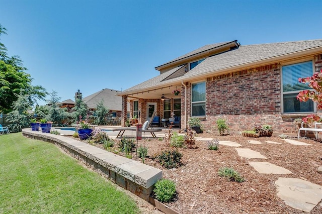 637 Branch Line Rd, Yukon, OK 73099 - rear view of property with ceiling fan, a patio, a yard, and brick siding
