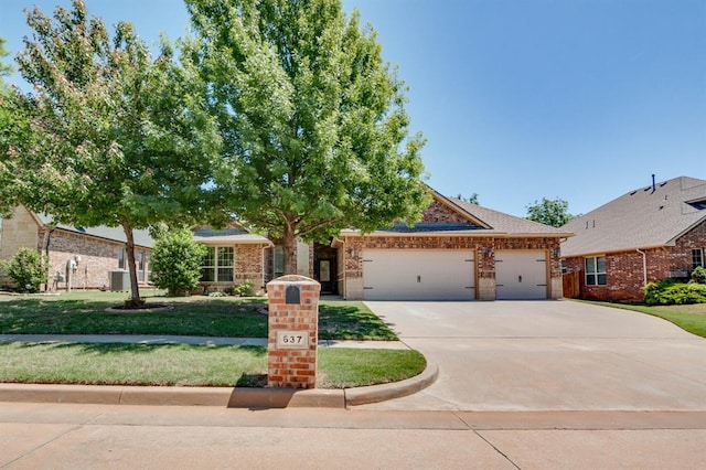637 Branch Line Rd, Yukon, OK 73099 - view of front of house featuring concrete driveway, an attached garage, a front yard, and brick siding