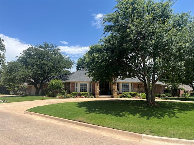 8700 N Waverly Ave, Oklahoma City, OK 73120 - view of front of property featuring a front yard, brick siding, and concrete driveway