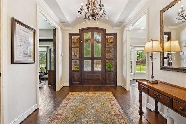 8700 N Waverly Ave, Oklahoma City, OK 73120 - foyer entrance featuring a chandelier, dark wood-style floors, vaulted ceiling, and crown molding