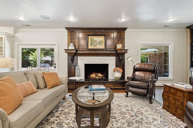 8700 N Waverly Ave, Oklahoma City, OK 73120 - living area with a fireplace, healthy amount of natural light, ornamental molding, wood finished floors, and recessed lighting