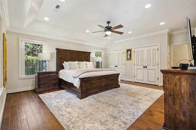 8700 N Waverly Ave, Oklahoma City, OK 73120 - bedroom with two closets, dark wood-style flooring, ornamental molding, recessed lighting, and a ceiling fan