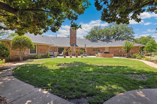 8700 N Waverly Ave, Oklahoma City, OK 73120 - ranch-style home with a front lawn, a chimney, brick siding, and a patio area