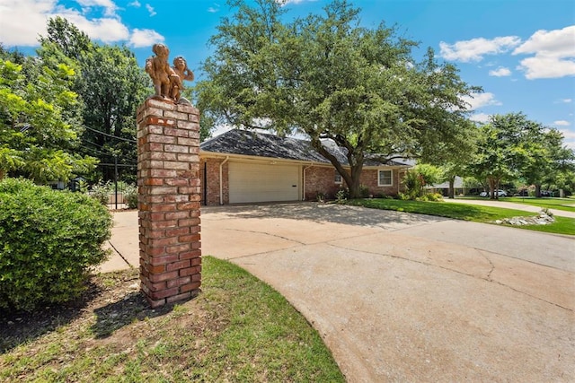 8700 N Waverly Ave, Oklahoma City, OK 73120 - view of front of home featuring an attached garage, driveway, brick siding, and a front yard