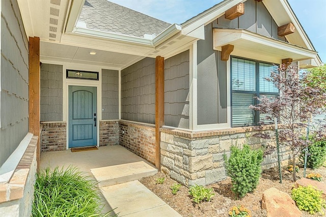 17817 Morning Sky Ct, Edmond, OK 73012 - entrance to property featuring a shingled roof, brick siding, and covered porch
