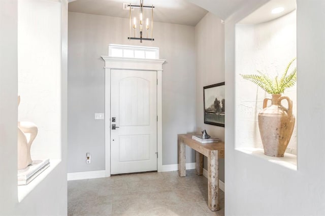 17817 Morning Sky Ct, Edmond, OK 73012 - tiled entryway featuring baseboards and a chandelier