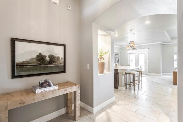 17817 Morning Sky Ct, Edmond, OK 73012 - hall with light tile patterned flooring, a chandelier, and crown molding