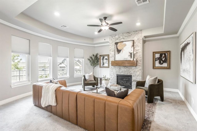 17817 Morning Sky Ct, Edmond, OK 73012 - living area with a fireplace, a ceiling fan, light carpet, a raised ceiling, and recessed lighting