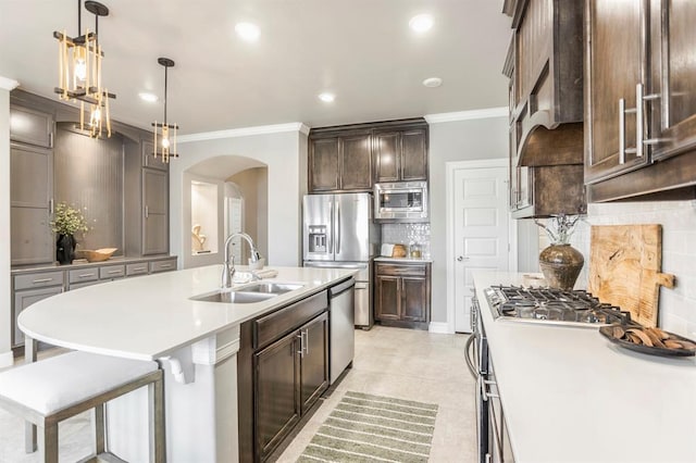17817 Morning Sky Ct, Edmond, OK 73012 - kitchen featuring arched walkways, ornamental molding, stainless steel appliances, decorative backsplash, and light countertops