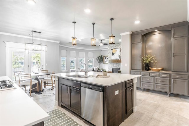 17817 Morning Sky Ct, Edmond, OK 73012 - kitchen with stainless steel appliances, ornamental molding, light countertops, ceiling fan, and a stone fireplace