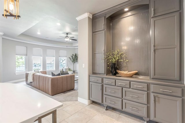17817 Morning Sky Ct, Edmond, OK 73012 - kitchen featuring gray cabinets, ceiling fan, a tray ceiling, light tile patterned flooring, and recessed lighting
