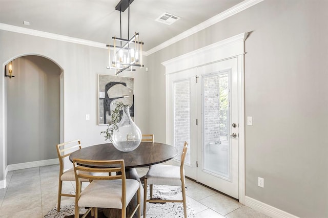17817 Morning Sky Ct, Edmond, OK 73012 - dining space with arched walkways, crown molding, a chandelier, and light tile patterned flooring