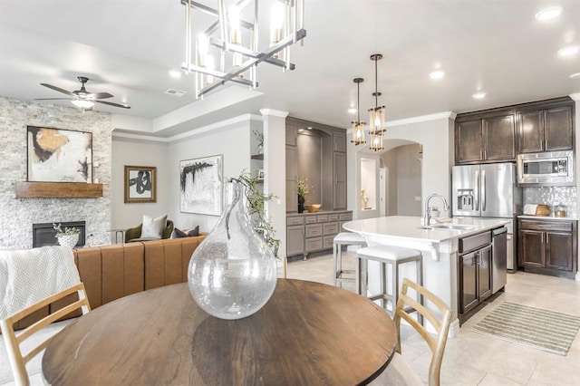 17817 Morning Sky Ct, Edmond, OK 73012 - dining area featuring ornamental molding, recessed lighting, ceiling fan, a stone fireplace, and light tile patterned floors