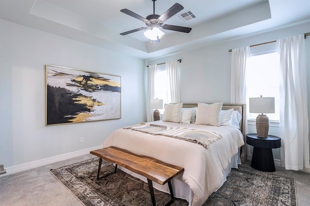 17817 Morning Sky Ct, Edmond, OK 73012 - carpeted bedroom with a tray ceiling and a ceiling fan