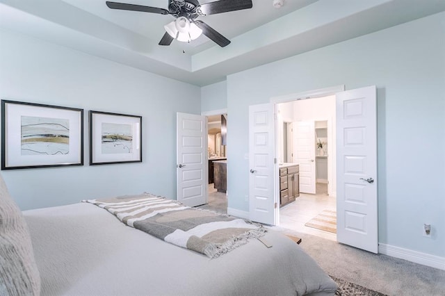 17817 Morning Sky Ct, Edmond, OK 73012 - bedroom with light carpet, ensuite bathroom, a tray ceiling, and ceiling fan
