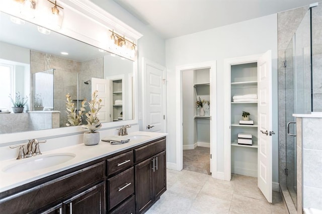 17817 Morning Sky Ct, Edmond, OK 73012 - full bath featuring a stall shower, double vanity, a spacious closet, and tile patterned floors