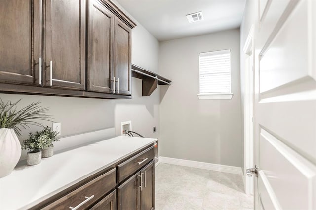 17817 Morning Sky Ct, Edmond, OK 73012 - laundry area with electric dryer hookup, cabinet space, and washer hookup
