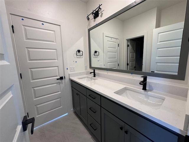 6101 Kinnick Dr, Edmond, OK 73034 - bathroom featuring double vanity and marble look tiles